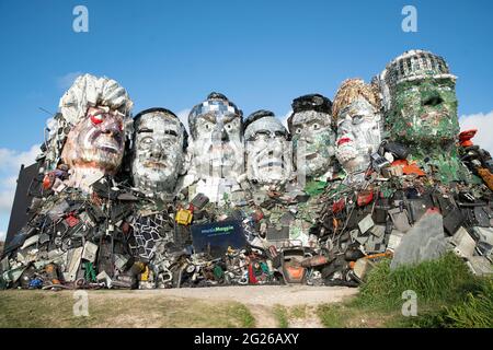 EDITORIAL USE ONLY Mount Recyclemore: The E7, which has been created out of e-waste, in the likeness of the G7 leaders and in the style of Mount Rushmore by British artist Joe Rush for tech recommerce expert musicMagpie, is unveiled on Sandy Acres Beach in Cornwall ahead of the G7 Summit starting later this week. Picture date: Tuesday June 8, 2021. Stock Photo