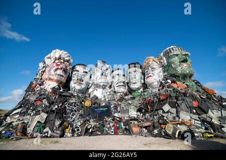 EDITORIAL USE ONLY Mount Recyclemore: The E7, which has been created out of e-waste, in the likeness of the G7 leaders and in the style of Mount Rushmore by British artist Joe Rush for tech recommerce expert musicMagpie, is unveiled on Sandy Acres Beach in Cornwall ahead of the G7 Summit starting later this week. Picture date: Tuesday June 8, 2021. Stock Photo