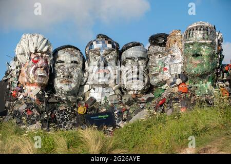 **EDITORIAL USE ONLY** Mount Recyclemore: The E7, which has been created out of e-waste, in the likeness of the G7 leaders and in the style of Mount Rushmore by British artist Joe Rush for tech recommerce expert musicMagpie, is unveiled on Sandy Acres Beach in Cornwall ahead of the G7 Summit starting later this week. Picture date: Tuesday June 8, 2021. Stock Photo