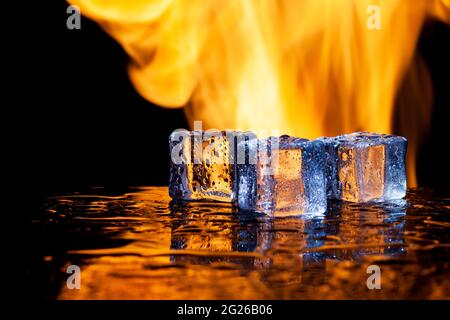 three ice cubes against the background of fire, fire and ice, place under the text Stock Photo