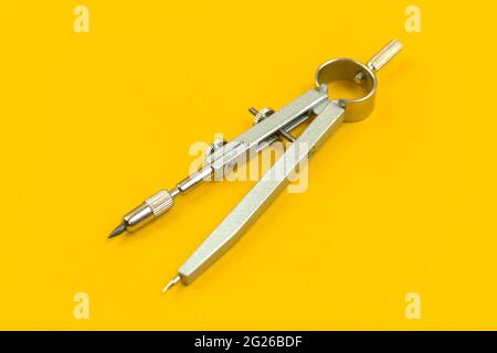 School drawing compass close-up on a office desk background, isolated Stock Photo