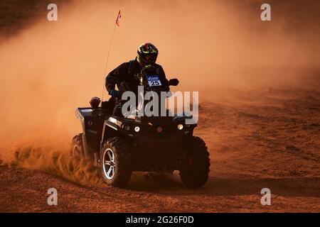Quad Bike for Off Road Extreme Racing gets over the difficult part of the route during the Rally raid in sand. THE GOLD OF KAGAN-2021. 25.04.2021 Astr Stock Photo