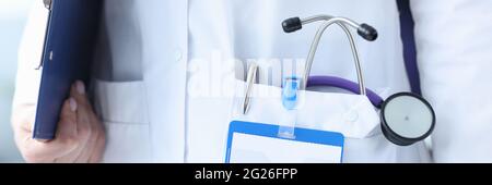 Closeup of phonendoscope and ballpoint pen in doctors pocket Stock Photo