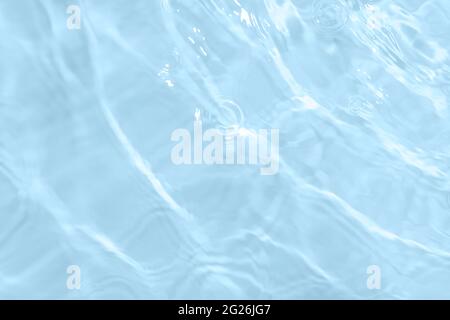 Surface of light blue transparent swimming pool water. Texture of transparent blue water in swimming pool. Trendy abstract nature background. Water Stock Photo