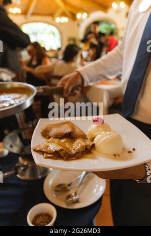 mexican dessert Cajeta crepes with vanilla ice cream close up caramel sauce Stock Photo