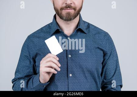 Bearded man cropped view in casual style shirt hold empty paper card for copy space, discount Stock Photo