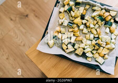 Healthy food background. Less meat concept. Vegetarian food on wooden background. Backing sheet with grilled seasoned vegetables. Lifestyle home Stock Photo