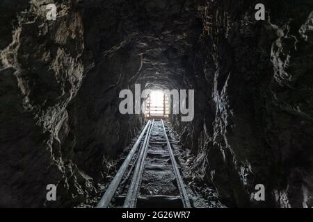 View inside an old scary abandoned gold mine tunnel.