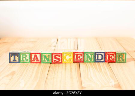 Spectacular wooden cubes with the word TRANSGENDER on a wooden surface. Stock Photo