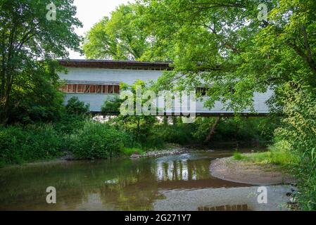 The Portland Mills Covered Bridge is the second oldest covered bridge in Parke County, Indiana. It was built in 1856 by Henry Wolfe in Burr arch truss Stock Photo