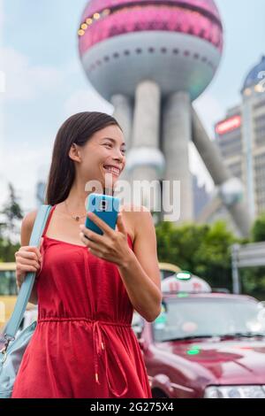 Asian lady using mobile pay phone app for taxi cab Stock Photo