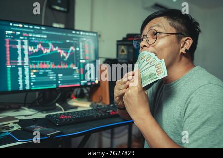Trader man happiness enjoying with Crypto trade online make money with blockchain platform Stock Photo