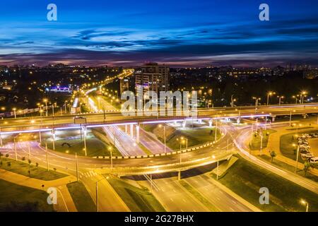 aerial drone photo of urban multilevel ring junction road in twilight time. long exposure. Stock Photo