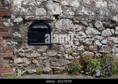 Close-up of an old mailbox on the outside wall of a house Stock Photo