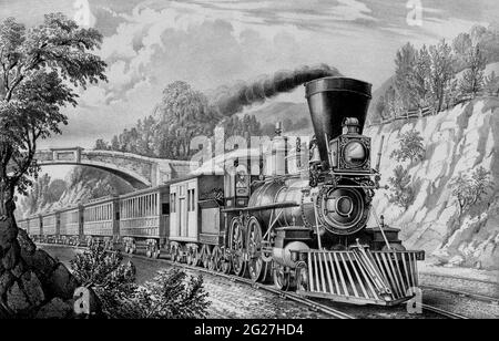 A train passing from under a bridge as part of the American railroads project during the 19th century. Stock Photo