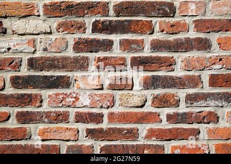 Old wall made of red bricks. Background with the surface of a brick wall. Stock Photo