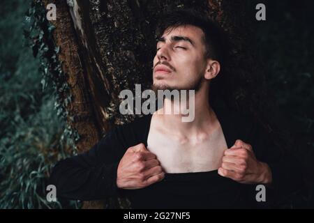 Young man protecting the forest trees, nature and people concept Stock Photo