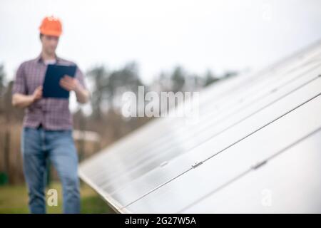 Special design surface and man in helmet with folder Stock Photo