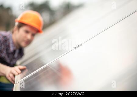 Man in helmet near flat surface of special design Stock Photo