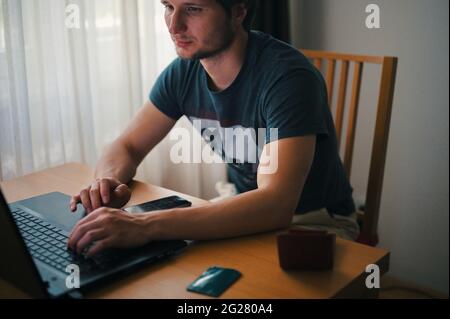 Mature man using laptop while sitting at home Stock Photo