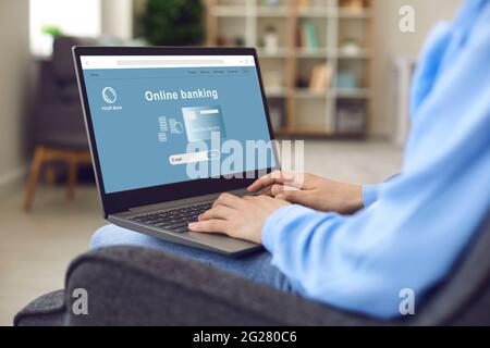 Woman using her laptop computer to open a bank account and transfer money online Stock Photo