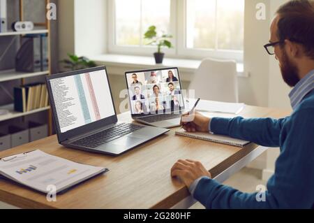 Business team manager having an online conference with his employees and coworkers Stock Photo