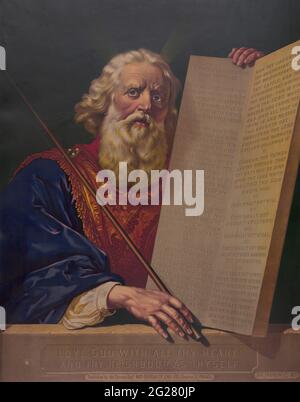 Moses holding the tablets inscribed with the Ten Commandments. Stock Photo