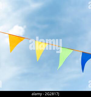 Ribbon made of multicolored triangles against the sky. Stock Photo
