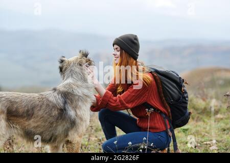 woman hiker next to dog mountains travel vacation Stock Photo