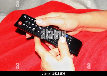 holding remote control with two hands Stock Photo