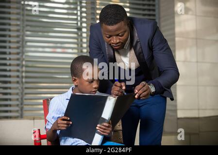 Family relationship between father and son. father or businessman teaches his child out of outdoor offices. Learning concept. Concept of relationships Stock Photo