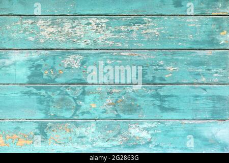 Background with wooden teal blue colored old weathered planks with chipped paint Stock Photo