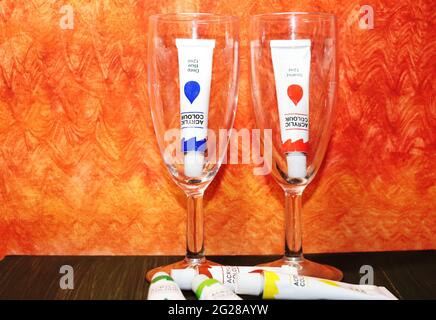 Glasses and paint in a tube, multi-colored paints Stock Photo