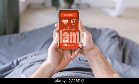 Unrecognizable man checking his health after waking up Stock Photo