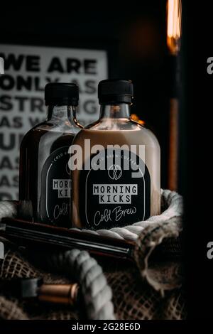 Cold Brew Coffee In Bottles Near Coffee Beans On White Table Stock 