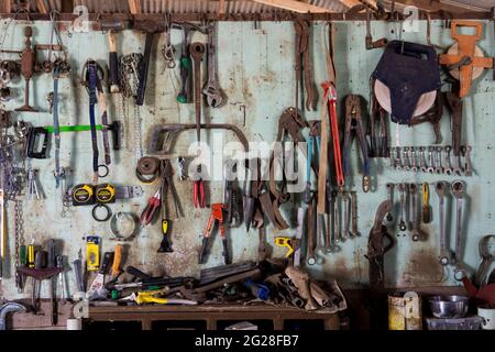 A wall of tools in an old farm shed in outback Queensland showing both modern and vintage tools. Stock Photo