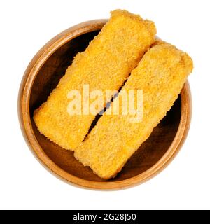 Vegan fishless fingers, ready to fry, in a wooden bowl. Fishless sticks, based on soy protein, breaded and crispy coated, pre-fried and cooked. Stock Photo