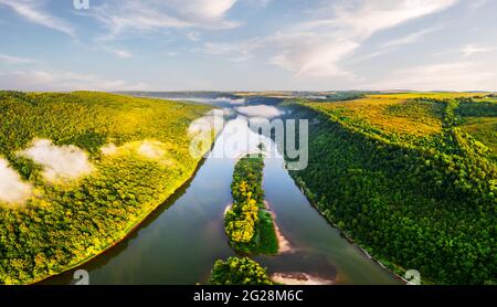 Flight through majestic foggy river and lush green forest at sunrise time. Landscape photography. Dnister, Ukraine, Europe Stock Photo