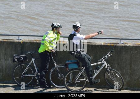 Two Police Officers from Newham MPS on a bike patrol visiting Gallions Point in the Royal Docks area of London Stock Photo