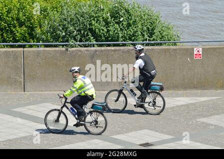 Two Police Officers from Newham MPS on a bike patrol visiting Gallions Point in the Royal Docks area of London Stock Photo