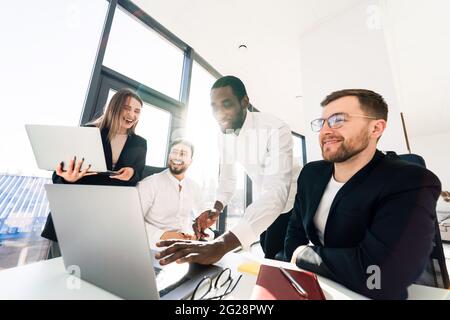 Happy office employee working together on laptop Stock Photo