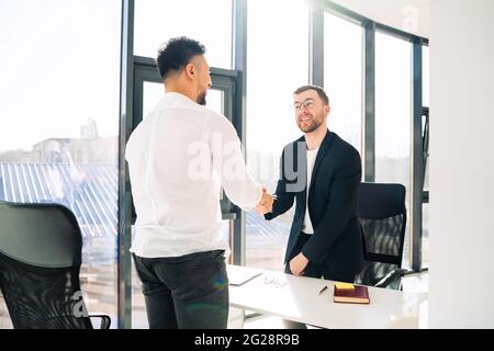 Two businessmen shake hands welcoming each other Stock Photo