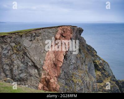 Striking mixes of different grey and red rock types in the coastal cliffs on the Ness of Hillswick in Northmavine, Mainland, Shetland, UK Stock Photo