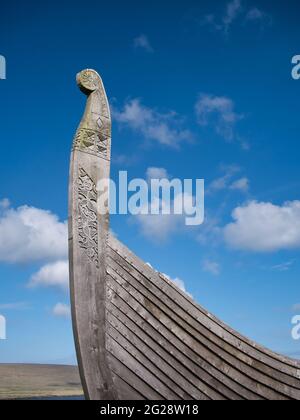 On a sunny day with light cloud, the prow of the Skidbladner - a full size replica of a Viking ship near Haroldswick on the island of Unst in Shetland Stock Photo