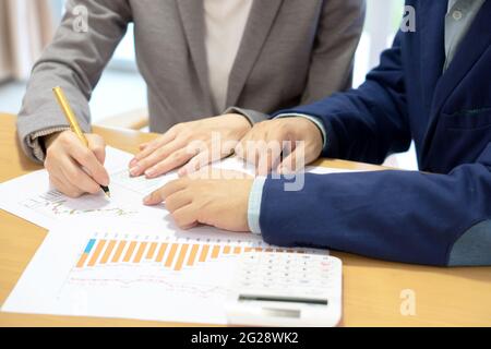 young consultant analyzing data with her client Stock Photo