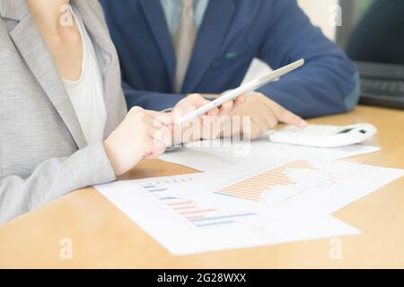 Business adviser analyzing financial figures denoting the progress in the work of the company Stock Photo