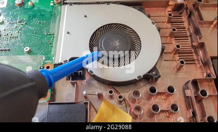 Closeup on a laptop cooler. Maintenance and prevention of the laptop cooling system. Electronic device repair concept. Dust and dirt on the computer f Stock Photo