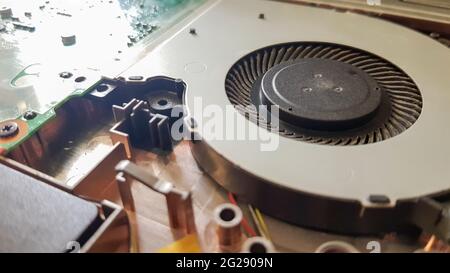Closeup on a laptop cooler. Maintenance and prevention of the laptop cooling system. Electronic device repair concept. Dust and dirt on the computer f Stock Photo
