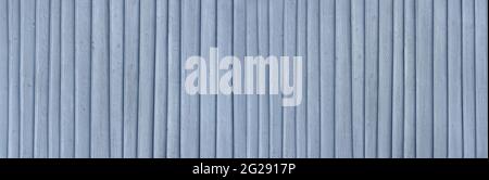 Plain light blue painted wooden wall with applied vertical strips Stock Photo