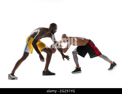 two men basketball players competition in silhouette isolated white background Stock Photo